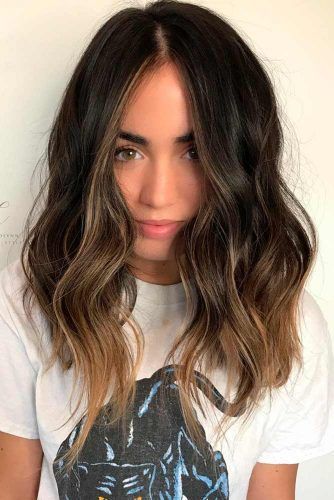 Butterfly cut on wavy hair with face-framing layers that fan outward